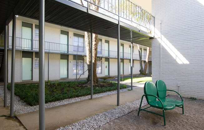 a patio with two chairs and a walkway in front of a building at The Junction, Memphis, TN, 38111