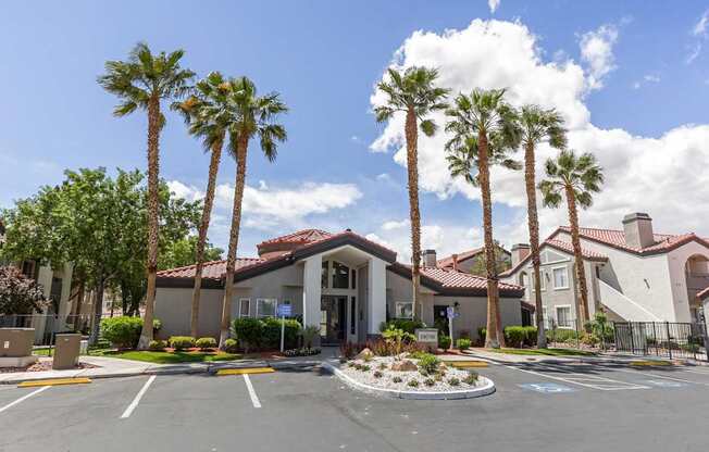 A building with palm trees in front of it.