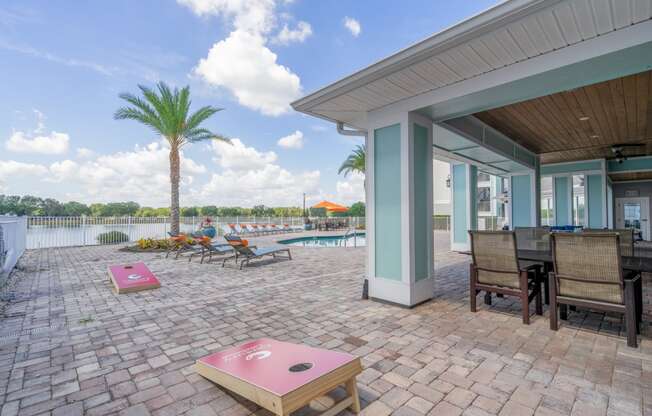 a patio with a pool and chairs and tables