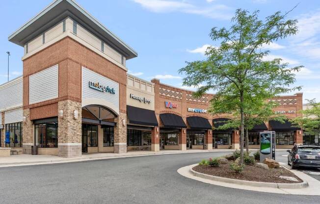 the front of a brick building with a parking lot