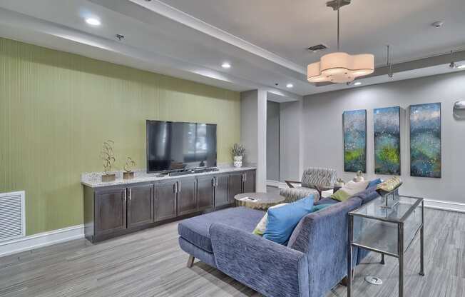 a man sitting on a couch watching tv in a living room at Nexus at Sandhill, South Carolina, 29229