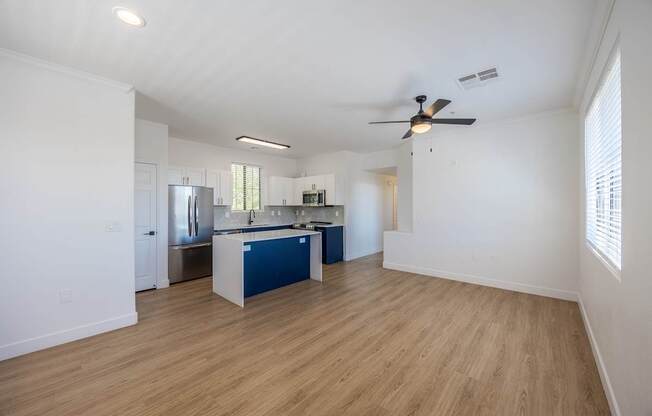 A kitchen with a blue island in the middle of the room.