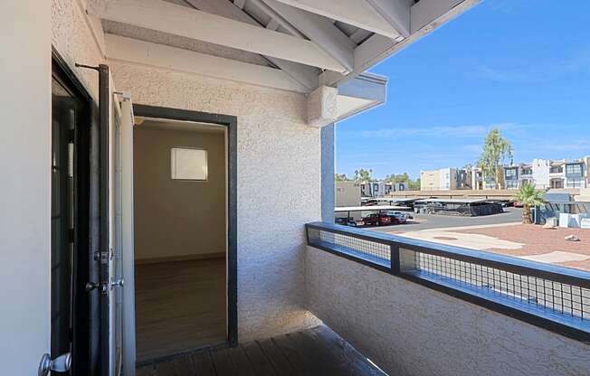 a balcony with a door and a view of the city
