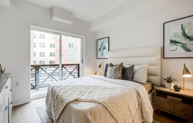 a bedroom with a bed and a sliding glass door to a balcony at Rialto, Washington District of Columbia