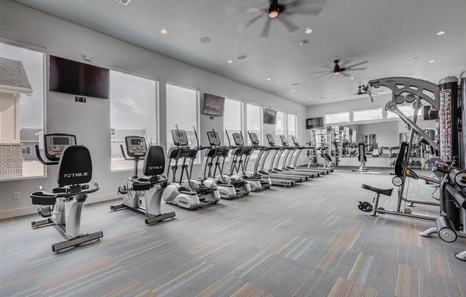 the gym is equipped with a row of exercise bikes  at Affinity 56 Apartments in West Jordan, Utah