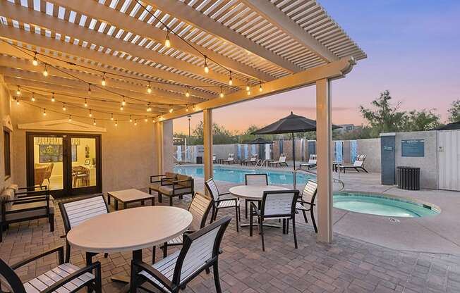 Community Patio Area with Lounge Furniture and View of Hot Tub at Ridgeline Apartments in Tucson, AZ.