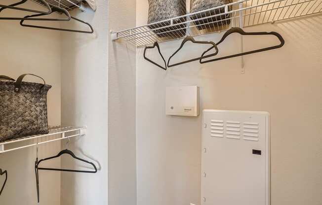 a laundry room with a clothes rack and a dryer