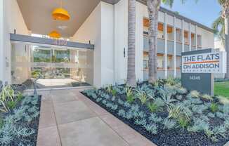 the flats on adelaide building entrance with palm trees at The Flats on Addison, Sherman Oaks, 91423
