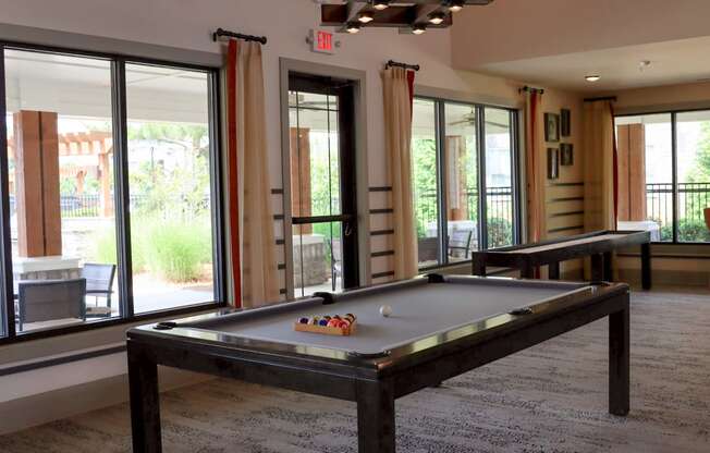 a game room with a pool table and a ping pong table