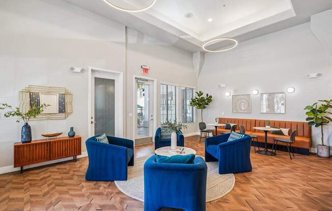 A room with blue chairs and a wooden bench.