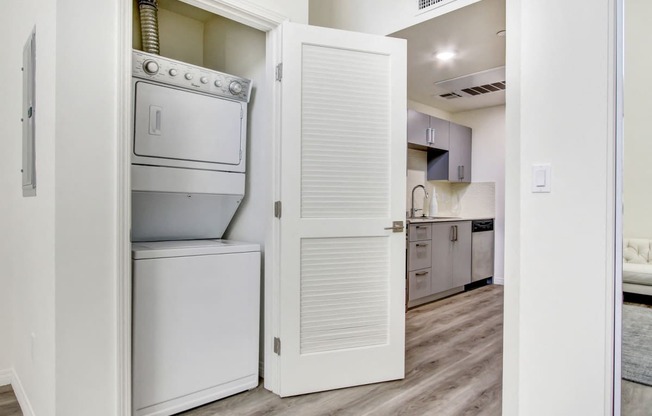 In-home Washer and Dryer, wood style floors throughout, kitchen on the right