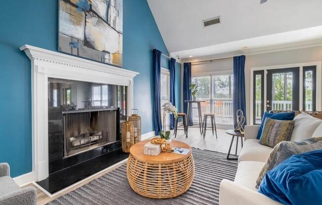 a living room with blue walls and a fireplace
