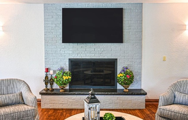 a living room with a fireplace and a flat screen tv on the wall