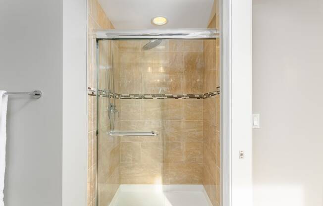 a shower with a glass door in a bathroom