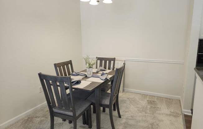 a dining room with a table and chairs