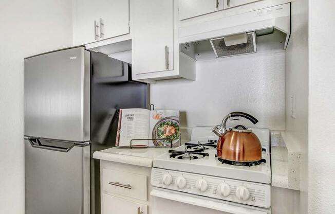 a kitchen with a stove top oven next to a refrigerator  at Sherway Villa, Reseda, California