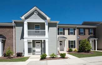 A row of houses with a clear blue sky above them.