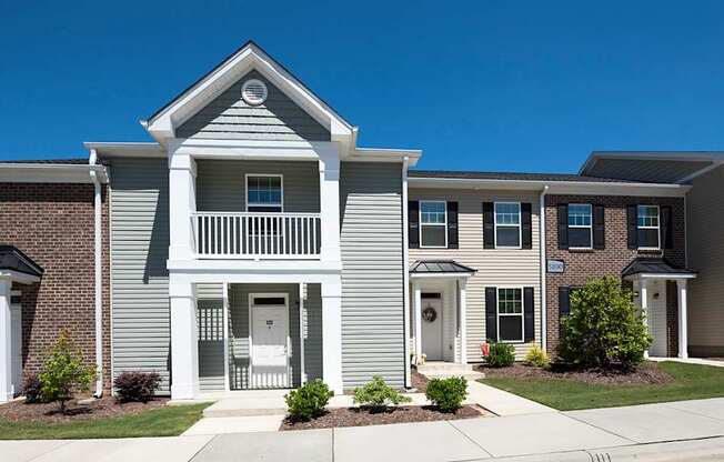 A row of houses with a clear blue sky above them.