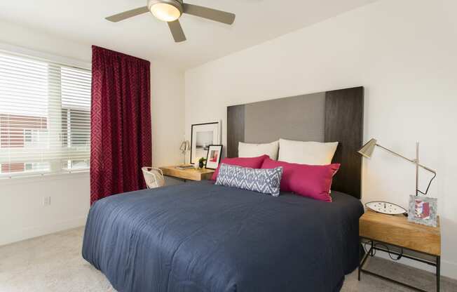 bedroom with large window and bed