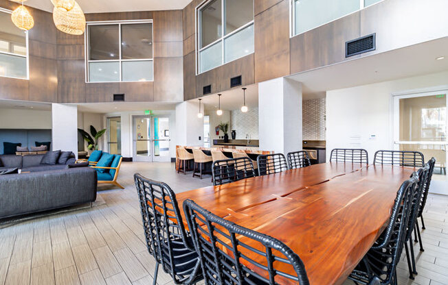 a large dining room with a long wooden table and chairs