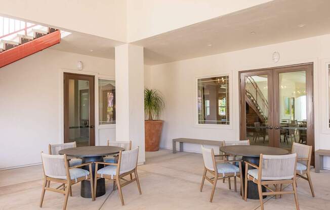 A dining room with a table and chairs.
