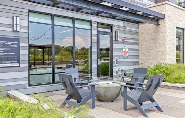 A grey building with a glass door and a sign on it.