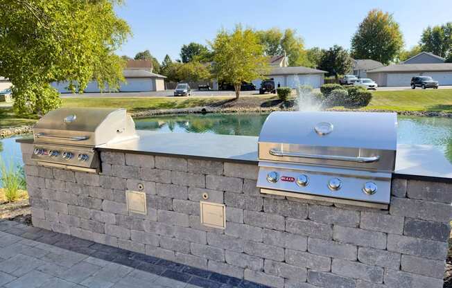 A stone wall with two built in BBQs.