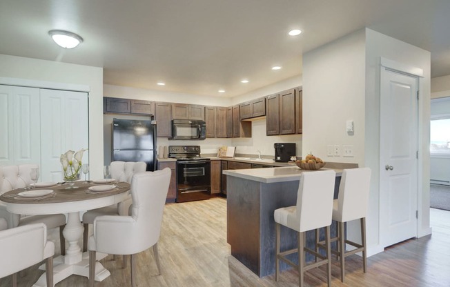 a kitchen and dining area with a table and chairs in a home at Madison Park, Bozeman, 59718