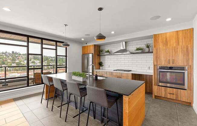 A modern kitchen with a large island and a view of the city.