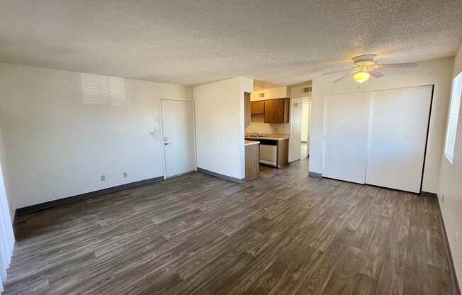 A room with wooden flooring and a ceiling fan.