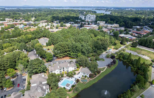 A bird's eye view of a residential area with a river running through it.