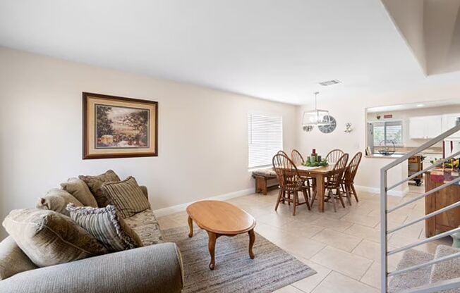 House has open kitchen with crisp white cabinetry with large backyard.