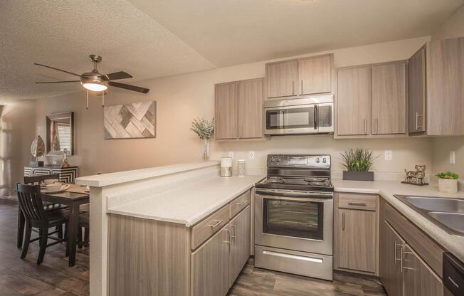 a kitchen with stainless steel appliances and wooden cabinets