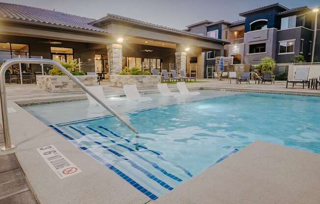 A night shot of the pool looking at the patio