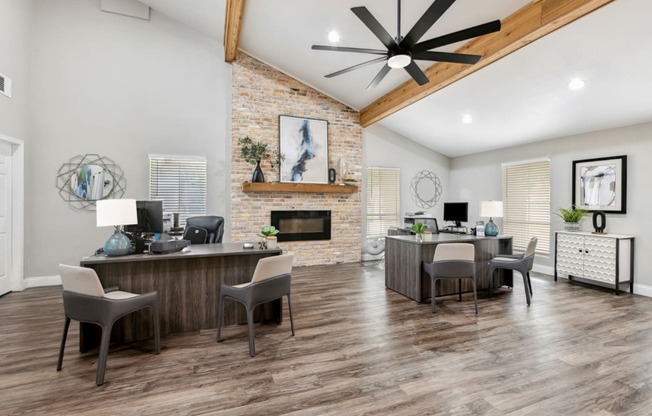 an open living room with a desk and a fireplace