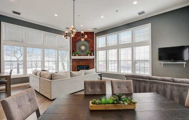 a living room with couches and a table and a television