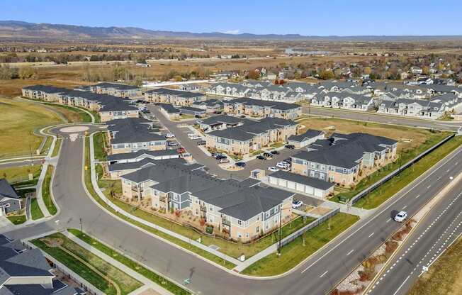 an aerial view of a neighborhood with houses and a highway
