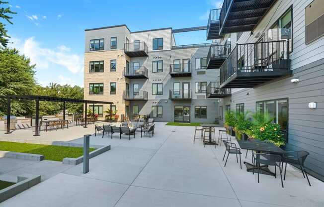 a patio with tables and chairs at the bradley braddock road station apartments