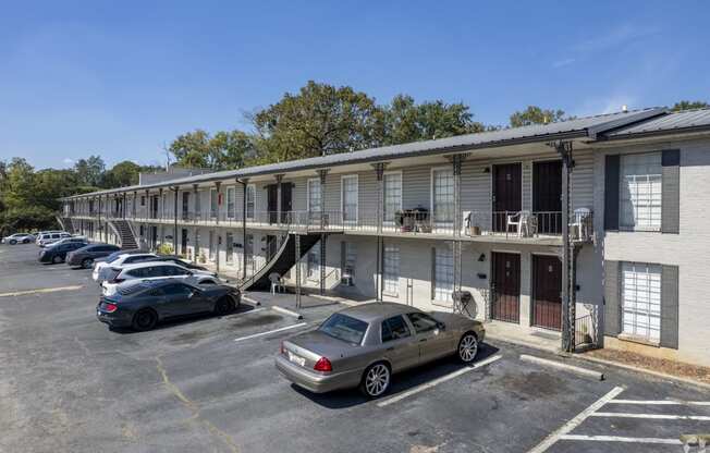 an apartment building with cars parked in front of it