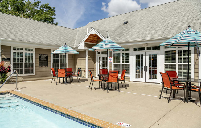 Apartments in Elk River MN_Pool deck with patio tables and chairs