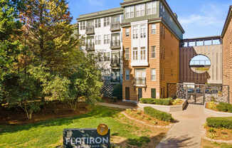 Flatiron West Trade Apartments exterior with monument sign and elevated walkway
