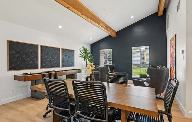 A conference room with a long table and chairs.