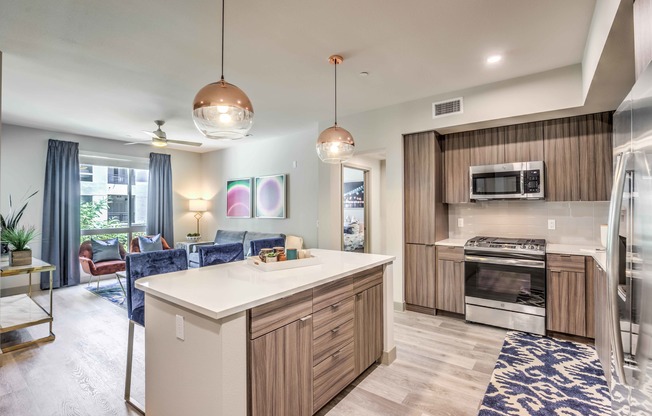 kitchen with vinyl wood like flooring and stainless steel appliances at Arte Apartments