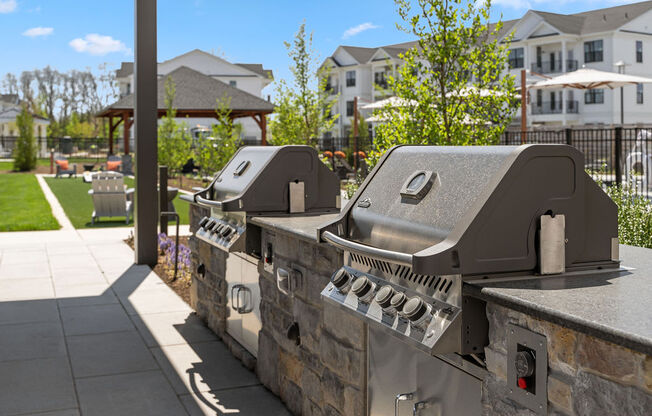 two bbq grills on a stone wall in front of a building at Madison Prickett Preserve, Yardley
