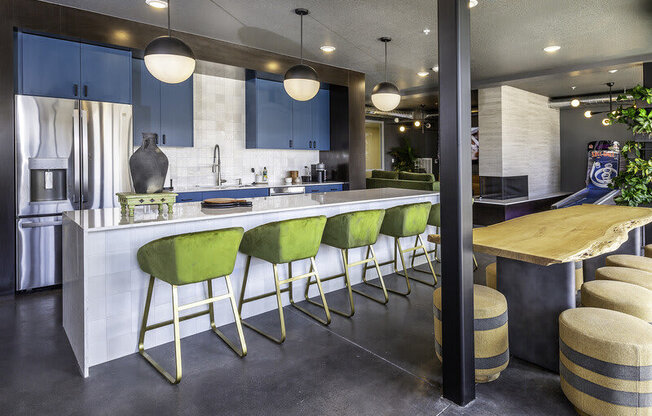 a kitchen with green bar stools and blue cabinets