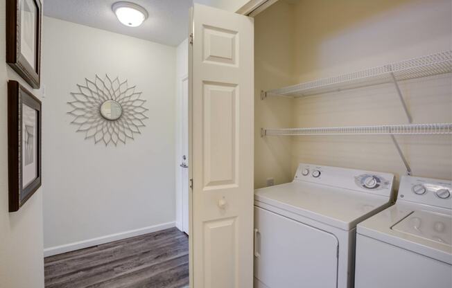 a white washer and dryer in a laundry room with a white door