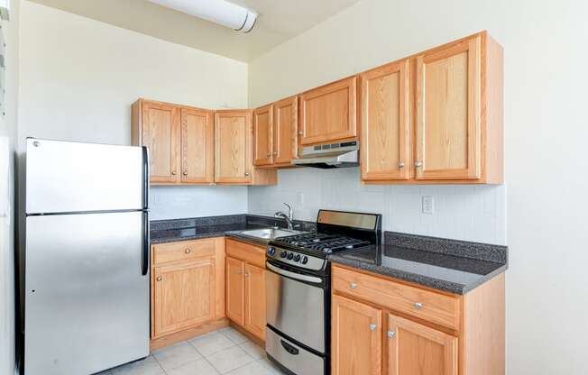kitchen with stainless steel appliances and wood cabinetry at norwood apartments in washington dc