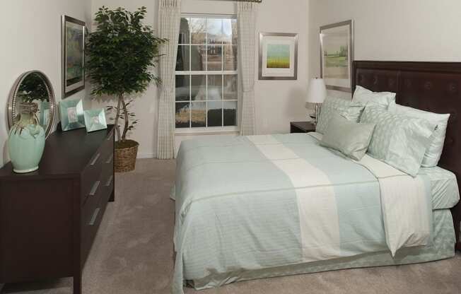 Bedroom with cozy bed at Versailles on the Lakes Schaumburg, Illinois