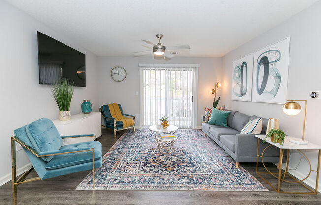 a living room with furniture and a ceiling fan