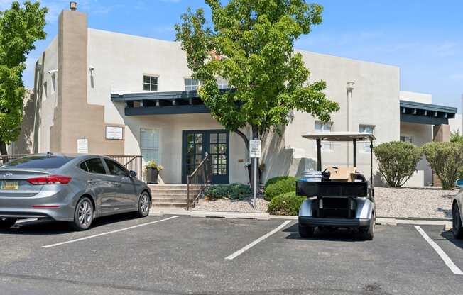 a golf cart parked in a parking lot in front of a building